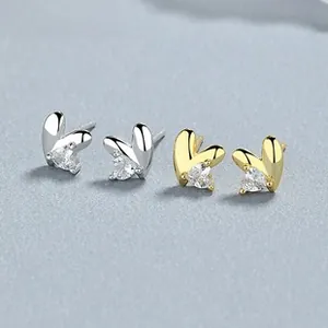 Detailed close-up of heart-shaped zircon earrings in gold and silver plating