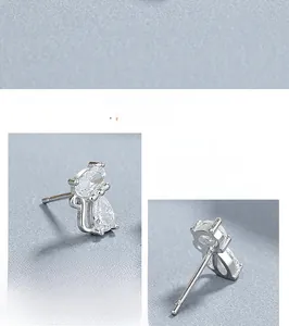 Macro detail of 925 sterling silver cat earrings featuring polished cubic zirconia stones