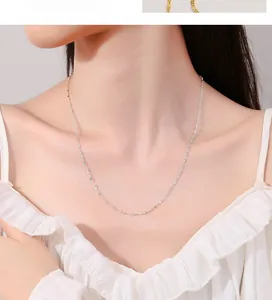 Close-up of sparkling 925 sterling silver figure-eight chain necklace on collarbone