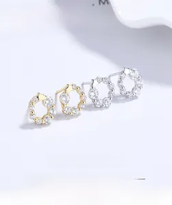 Detailed macro view of 925 sterling silver wreath earrings with sparkling zircon stones