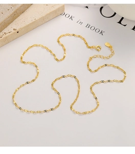 Close-up of golden S925 sterling silver flat butterfly link chain with lobster clasp