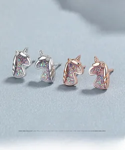 Detailed macro view of 925 sterling silver unicorn studs with sparkling pink glitter