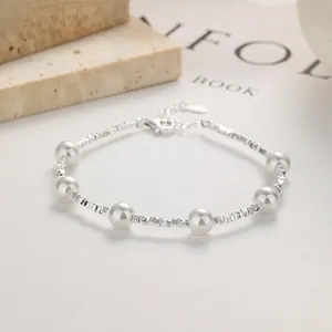 Detail of 925 sterling silver pearl bracelet featuring round pearls and faceted silver beads