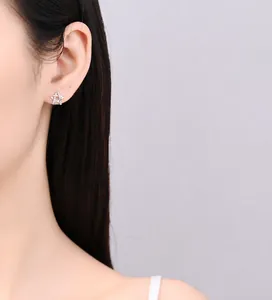Close-up of sparkling silver star stud earrings with zirconia inlays worn by a model