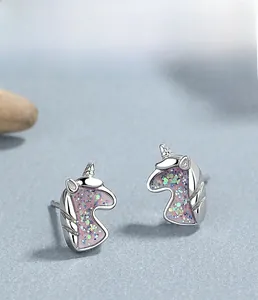 Detailed macro view of S925 sterling silver unicorn stud earrings with glitter finish