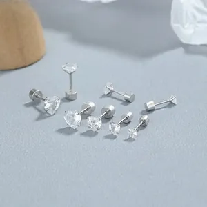 Detailed view of sterling silver heart and round cubic zirconia stud earrings with screw backs
