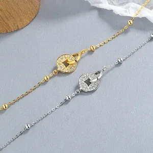 Detail of S925 silver coin bracelets with sparkling zircons in gold and silver finish