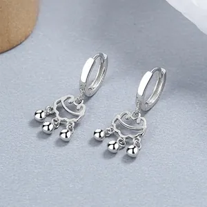 Detailed close-up of S925 silver hoop earrings with hollow auspicious cloud pendants