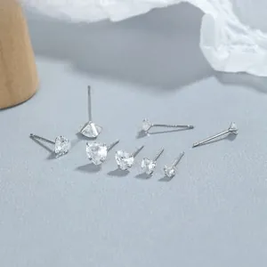 Macro shot of 925 sterling silver heart and round zircon stud earrings in various sizes