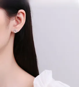Close-up of 925 sterling silver round hollow stud earrings with sparkling cubic zirconia