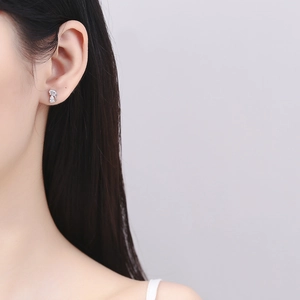 Minimalist 925 sterling silver cat stud earrings with sparkling cubic zirconia on model