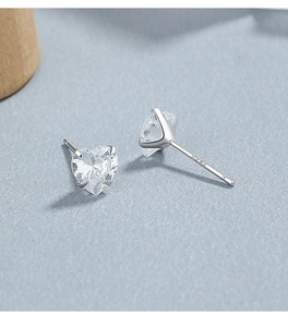 Macro shot of S925 sterling silver stamp on heart-shaped cubic zirconia stud earrings