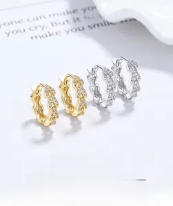 Detailed close-up of V-shaped sterling silver earrings with micro-pave cubic zirconia crystals