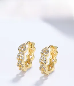 Macro shot of 925 silver gold-plated wheat grain earrings with sparkling zircon inlay