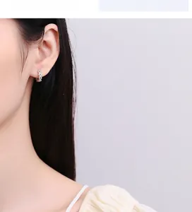 Detail of 925 sterling silver wheat-inspired hoop earring with micro diamonds on model