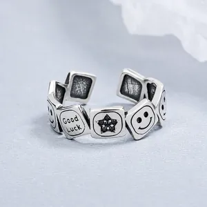 Macro detail of vintage 925 silver ring featuring engraved smileys and stars