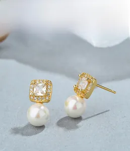 Detailed view of S925 silver pearl earrings with square cubic zirconia and gold plating