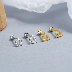 Detailed shot of crown earrings with inlaid crystals and screw-back in silver and gold