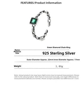 Detailed macro view of 925 silver vintage chain ring with emerald cut green stone