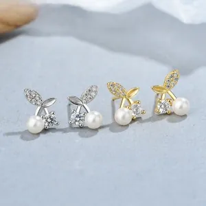Macro detail of cherry-shaped sterling silver pearl earrings with micro-set zircon leaves