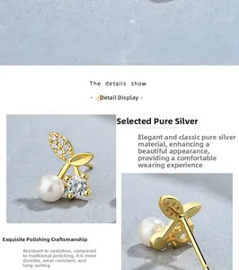 Macro detail of silver cherry earrings with pearls and pavé cubic zirconia inlay