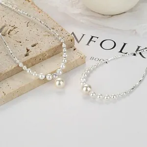 Detail of 925 silver pearl bracelet with sparkling zircon inlay on stone surface