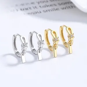 Macro shot of 925 sterling silver twisted hoop earrings with gold and silver finishes