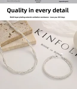 Detail of S925 sterling silver layered bracelet with white pearls on a textured stone
