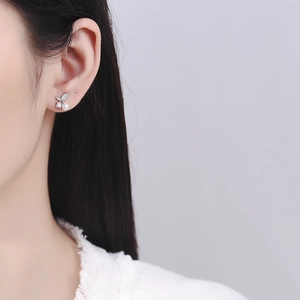 Elegant S925 silver cherry pearl stud earrings with leaf zircon design on a female model