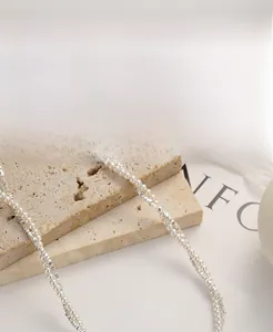 Detailed close-up of 925 sterling silver beads and white pearls on an elegant necklace