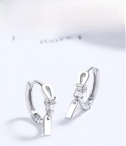Macro shot of S925 sterling silver hoop earrings with rectangular pendant and zircon