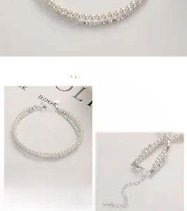 Detail of 925 sterling silver stamp and polished pearls on a double-layer bracelet