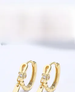 Detail of S925 sterling silver hoop earrings with gold plating and sparkling zircon