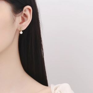 Elegant 925 silver crown pearl earrings with gold plating on female model