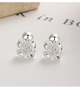 Macro view of 925 sterling silver cherry blossom studs with matte floral texture