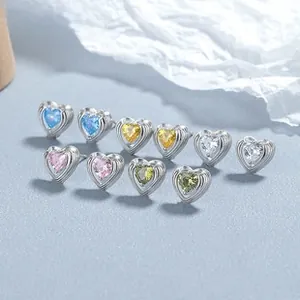 Detailed view of faceted heart-shaped zircon earrings in five vibrant colors