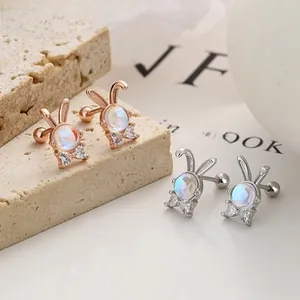 Detail of rabbit stud earrings in silver and rose gold with screw-back closures
