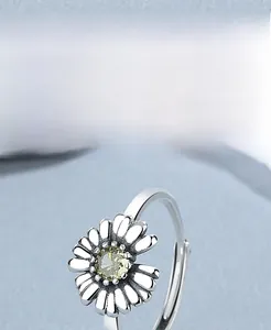 Macro shot of 925 sterling silver daisy ring with yellow gemstone and adjustable band