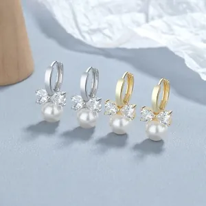 Detail of 925 silver and gold bow earrings with crystal pave and shell pearls