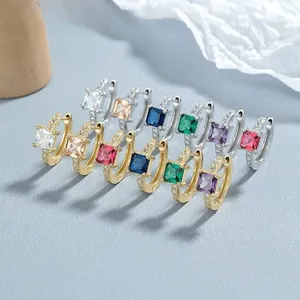 Macro shot of 925 silver hoop earrings with square gemstones and micro-pave detailing