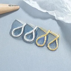 Detail of teardrop sterling silver stud earrings in gold and silver finishes