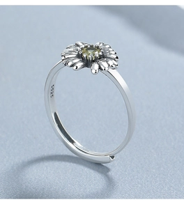 Macro detail of 925 sterling silver daisy ring showing S925 hallmark and yellow stone