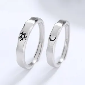 Close-up of 925 sterling silver adjustable sun and moon rings with brushed texture