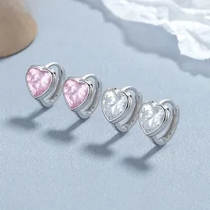 Macro view of S925 silver heart-cut earrings featuring pink and white cubic zirconia