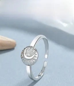 Macro detail of S925 sterling silver moon and starburst ring with embossed diamond accents