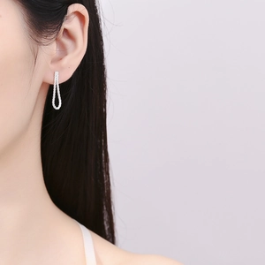 Elegant 925 sterling silver drop earrings with sparkling pavé zircons worn by a model
