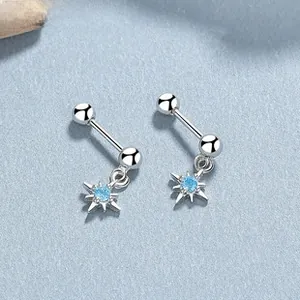 Macro detail of S925 silver star earrings featuring light blue cubic zirconia stones