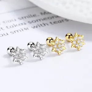 Detailed macro view of S925 sterling silver snowflake earrings with cubic zirconia stones