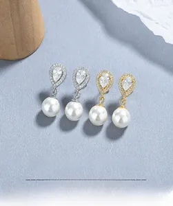 Detail of S925 sterling silver teardrop earrings with pave crystals and white pearls