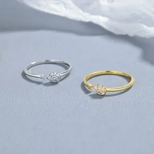 Detail of 925 silver and gold rose rings with white enamel and tiny zircon stones